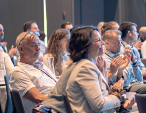 People sitting at an event and listening