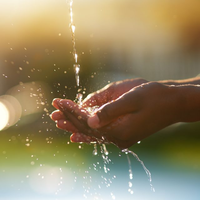 Water is precious. Closeup shot of hands held out under a stream of water