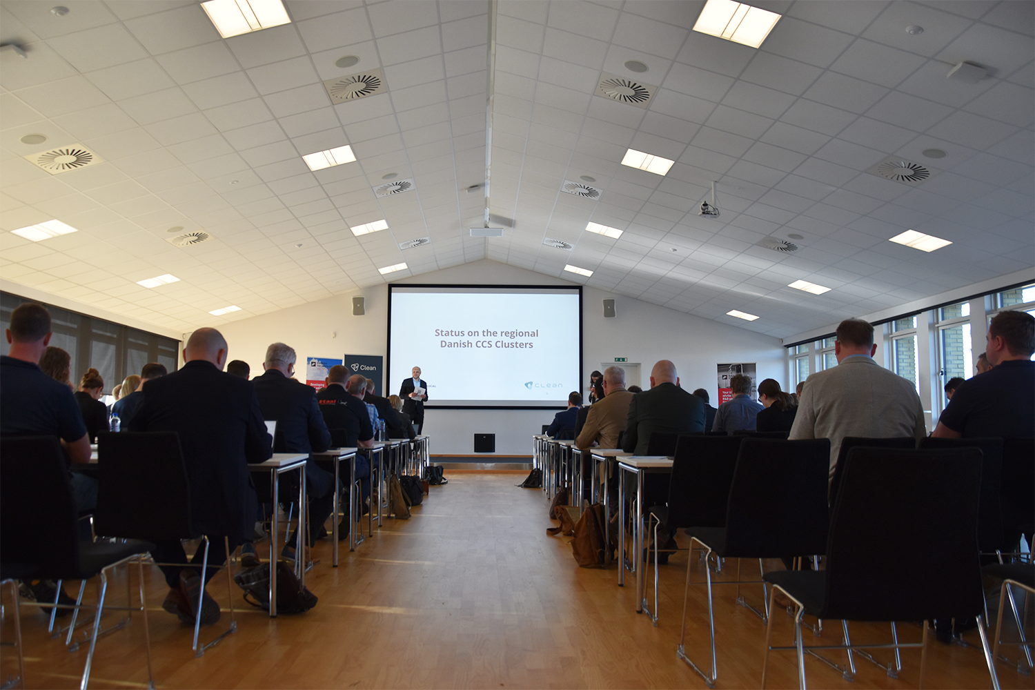 a room with a dias show and lots of people